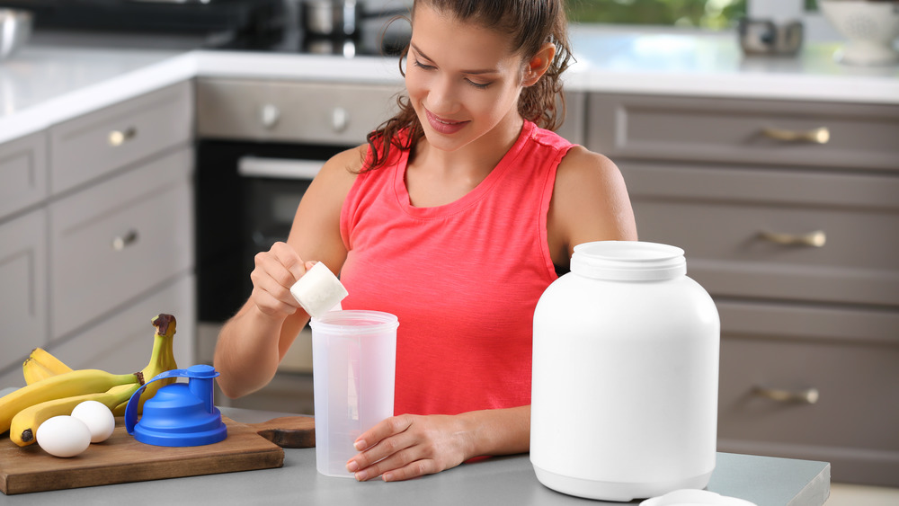 Woman preparing protein shake