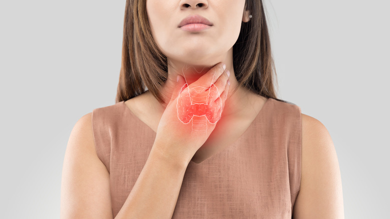 Woman touching her sore throat