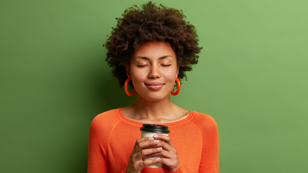 Woman holding coffee 