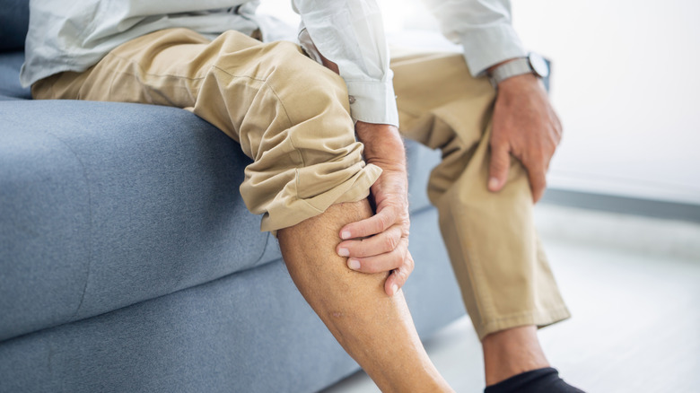 Man holding his legs in pain
