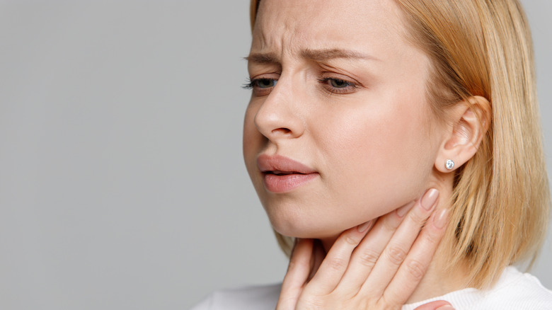 woman with hands on lymph nodes in neck