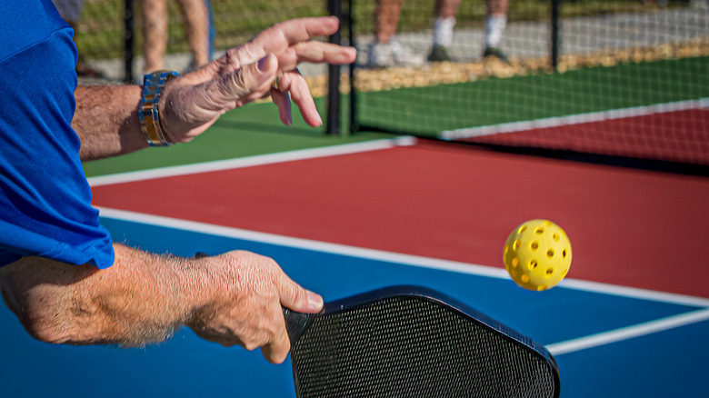 Older man playing pickleball