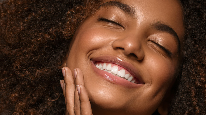 Black woman smiling with eyes closed