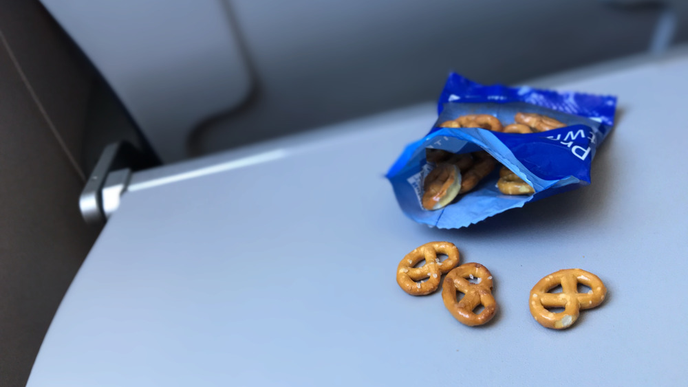 an open bag of pretzels on a tray in a plane