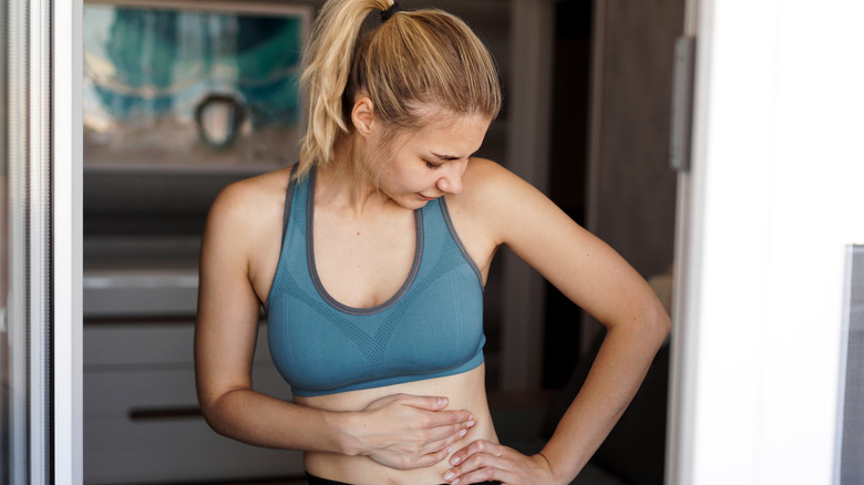 woman touching her stomach