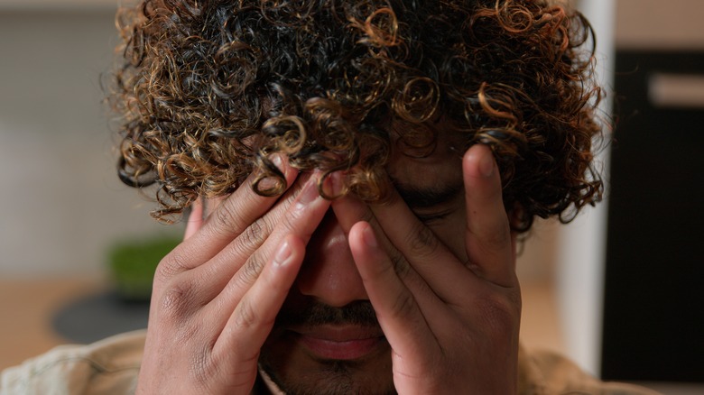 Man rubbing eyes