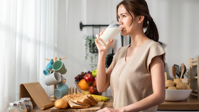 woman drinking a glass of milk