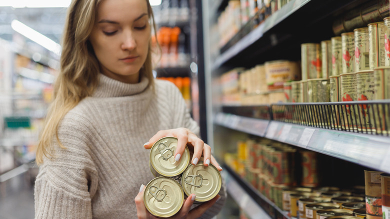 Woman buying canned goods