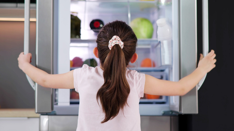 Child looking in fridge
