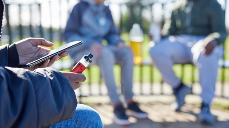 teen holding a vape