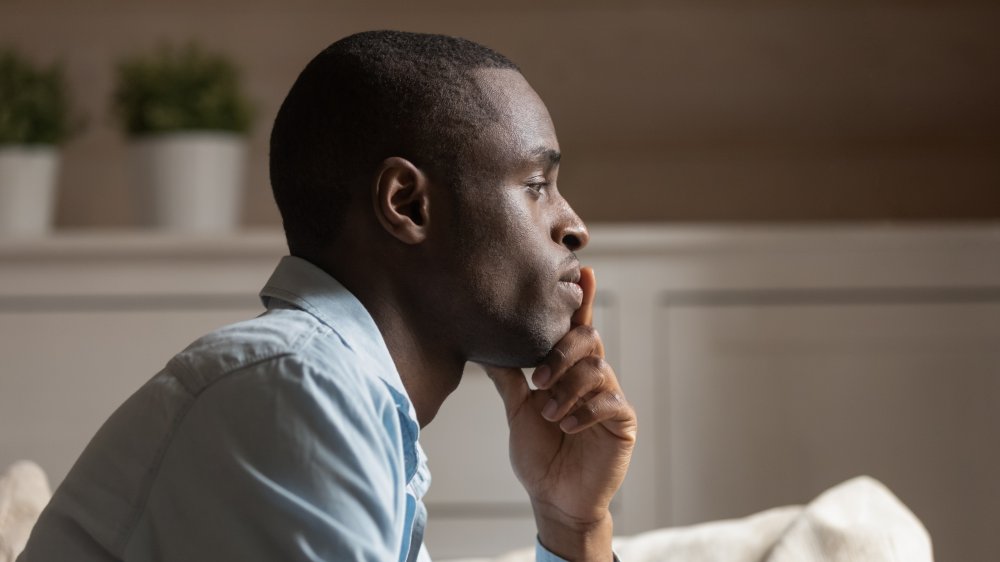 Side profile of a man who looks like he is going through a breakup 