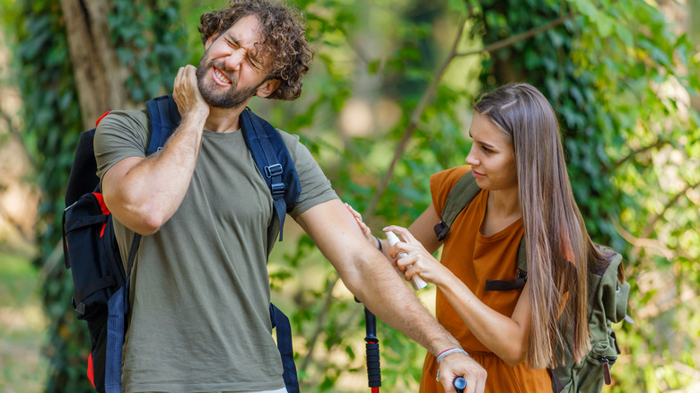 hiking couple treating mosquito bites