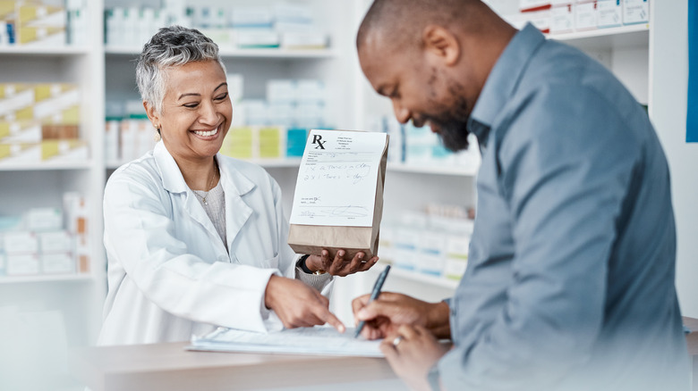 Customer picking up pharmacy prescription