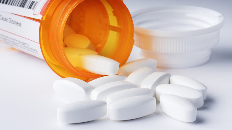 Open pill bottle with pills