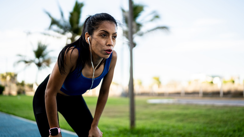 fit woman exhausted after outdoor workout