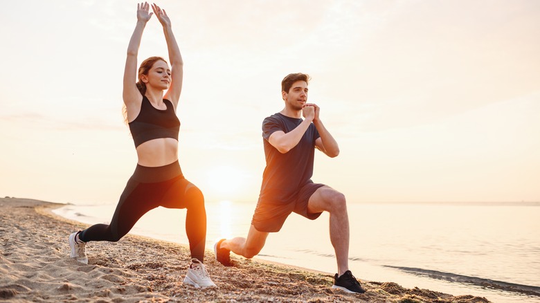 Couple lunging on beach