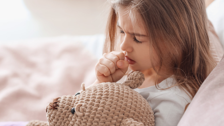 Child undergoing chemotherapy holding a balloon