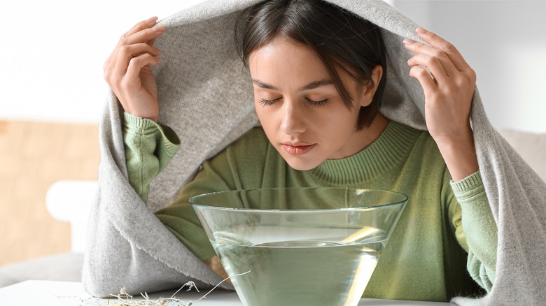 woman using steam to clear her respiratory system
