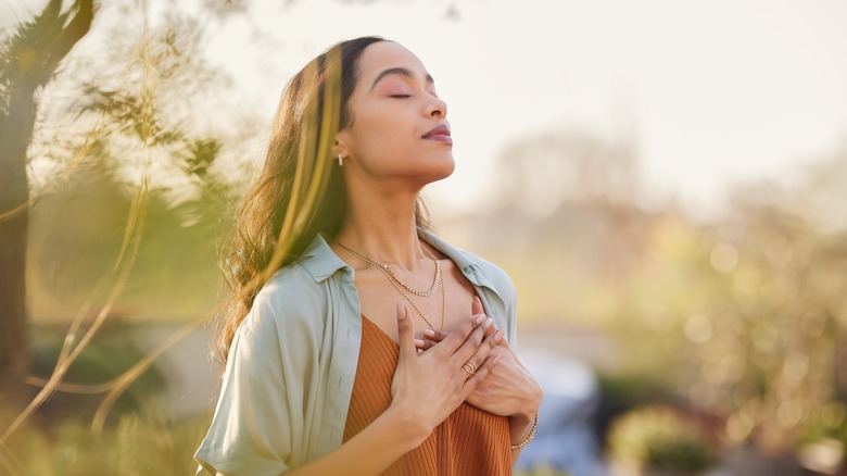 woman enjoying breathing outside