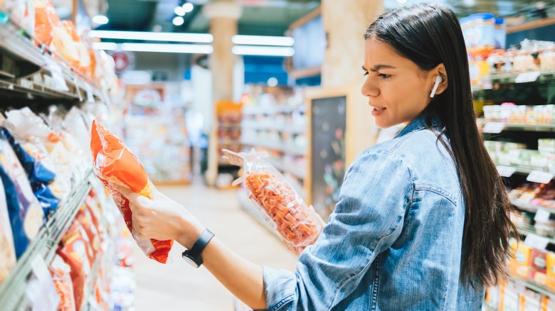 Woman looking at food label