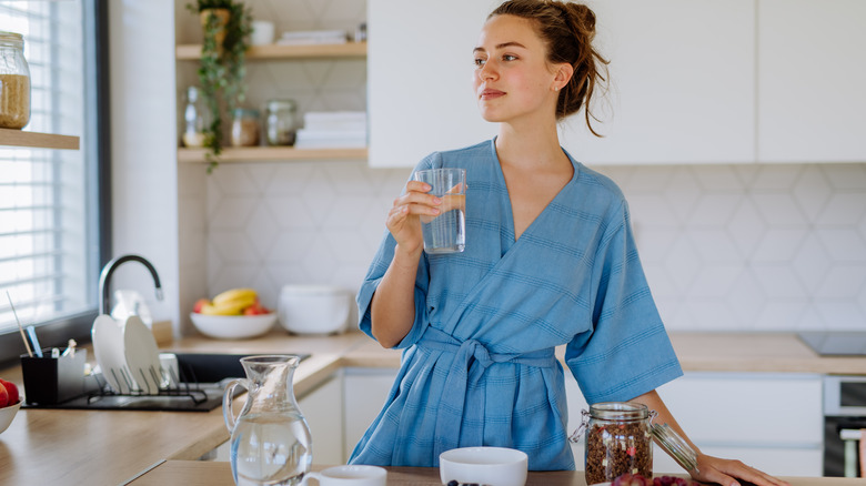 Woman holding glass of water