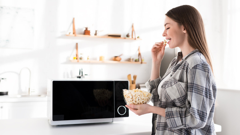 Woman eating microwave popcorn