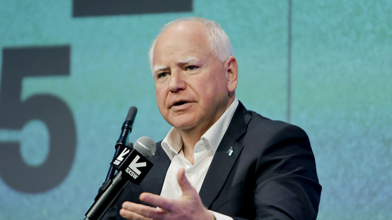 Minnesota Governor Tim Walz behind a microphone