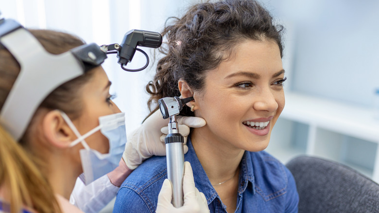 Woman gets ear exam