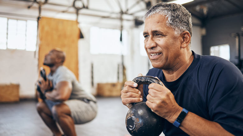 men using kettlebells