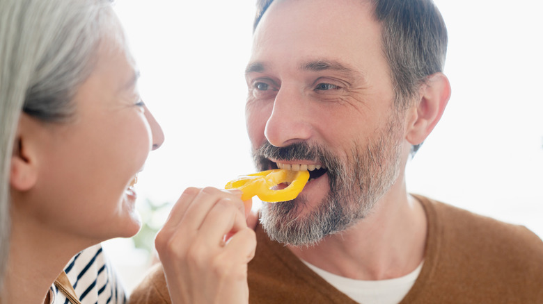 woman feeding man food