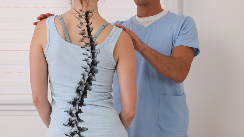 Woman with scoliosis examined by a doctor