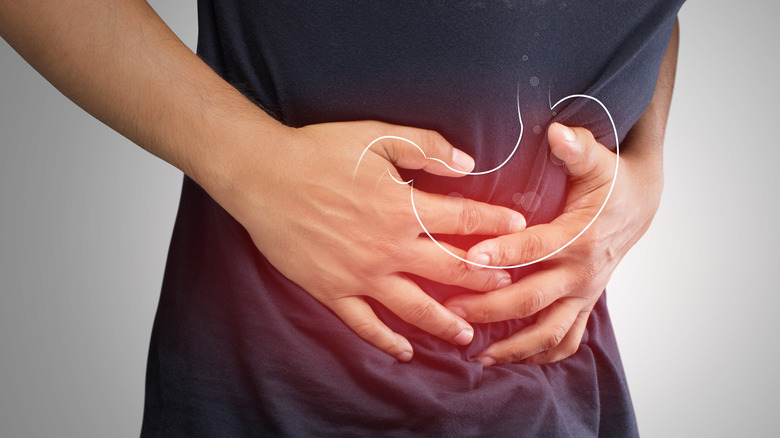 person holding stomach with acid reflux