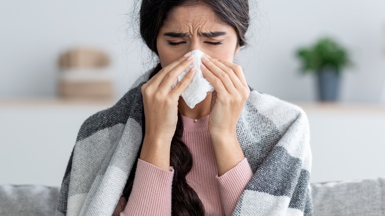 woman with flu on couch