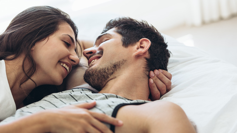 Young couple laying in bed