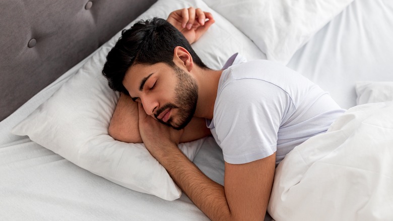 Bearded man asleep in bed