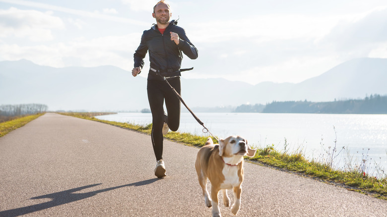 A man runs with his dog
