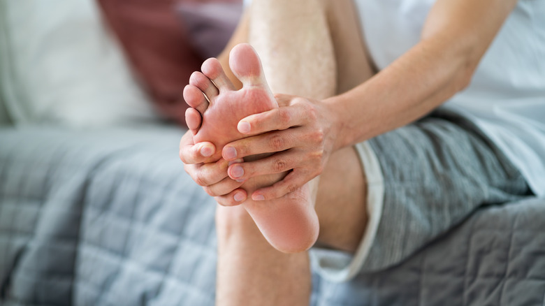 a man massaging his foot