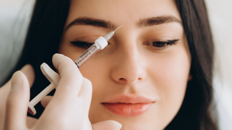 a young woman getting botox injections
