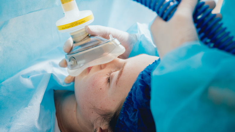 Patient with breathing tube on face