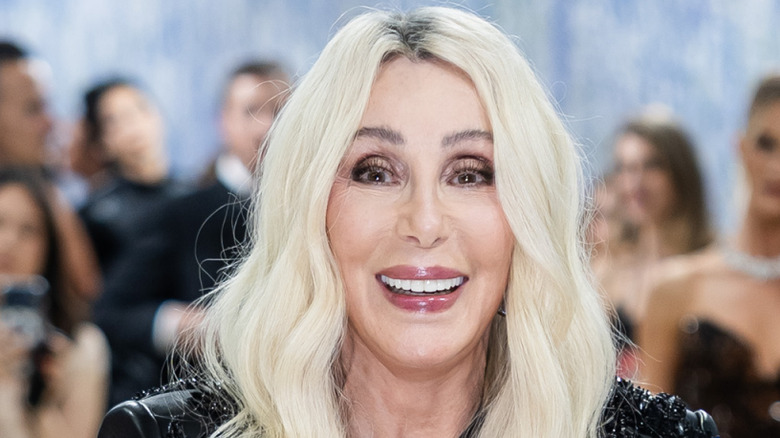 Cher smiling for the camera at a red carpet event
