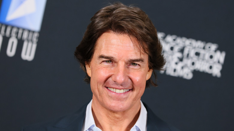 Tom Cruise smiling and posing at an event