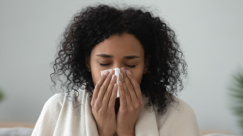 Ill black woman cleaning nose