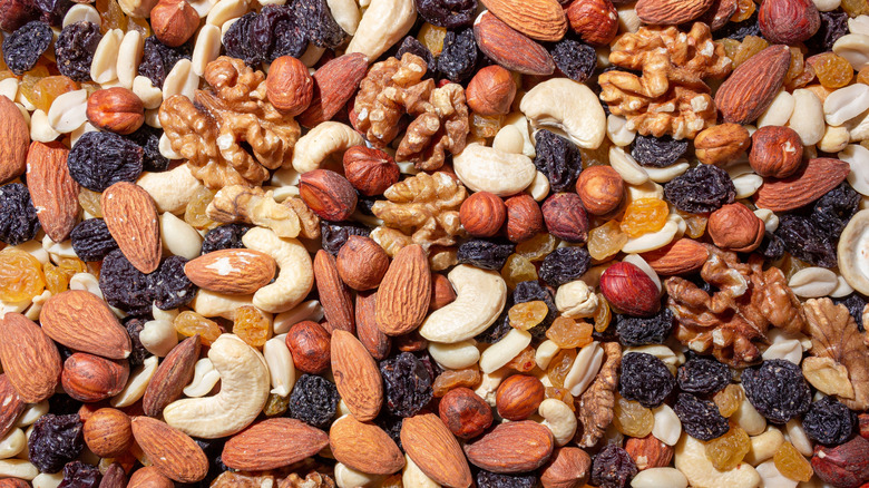 A variety of nuts, seeds, and dried fruits spread on a table