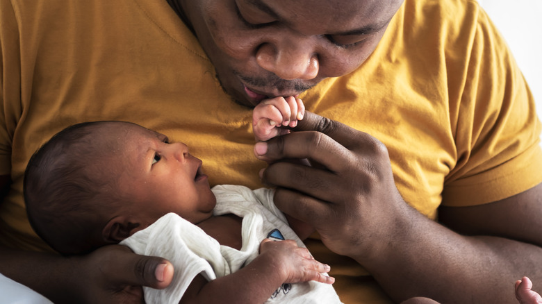 Black father kissing baby