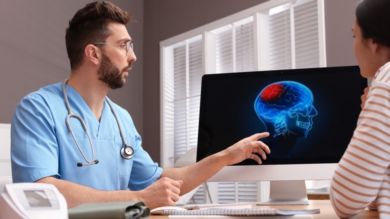 Doctor showing brain scan to patient