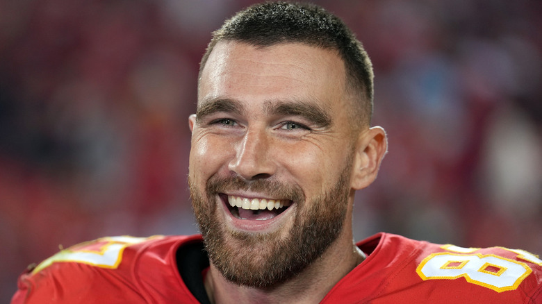 Travis Kelce smiling while being interviewed after the Chiefs defeated the Las Vegas Raiders