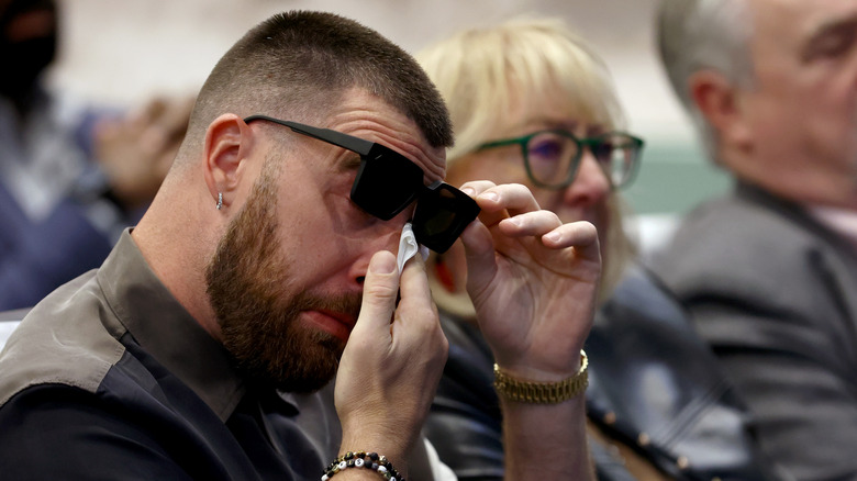 Travis Kelce wiping his tears away during his brother Jason's retirement from the NFL at NovaCare Complex