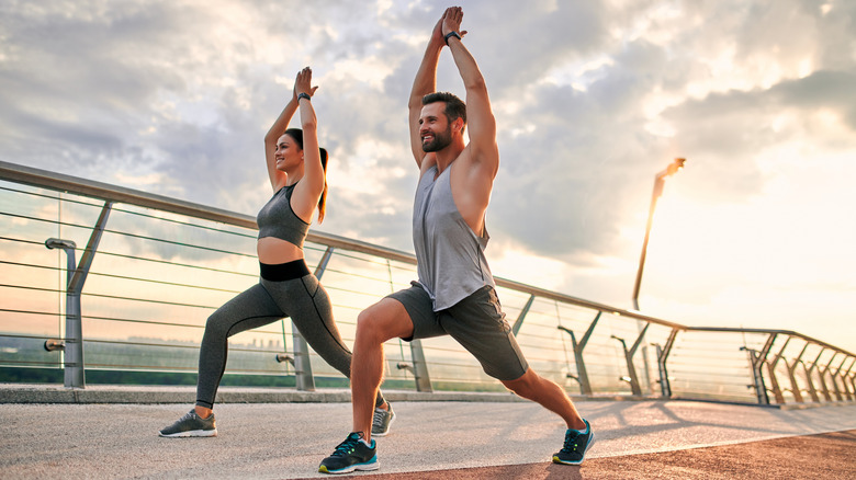 a woman and man working out together 