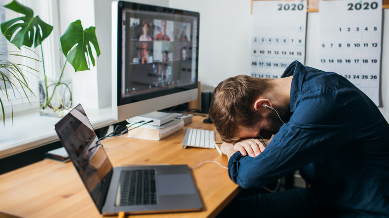 Man with head on desk sleeping