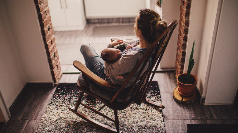 Mother in rocking chair with baby